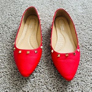 Red slip on flat shoe with gold accents. Size 9